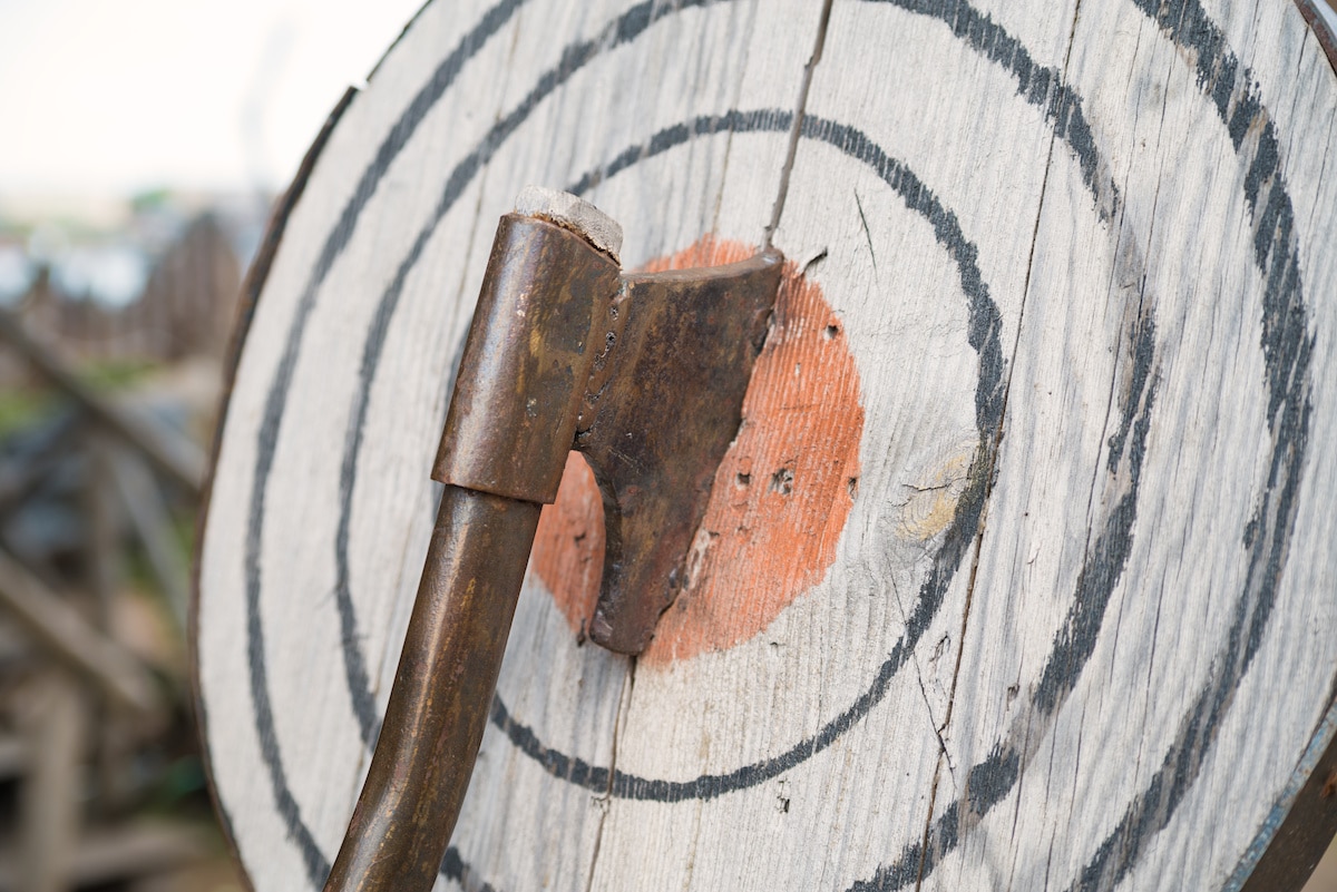 An ax embedded in the center of a wooden target at the Arkansas Renaissance Festival.